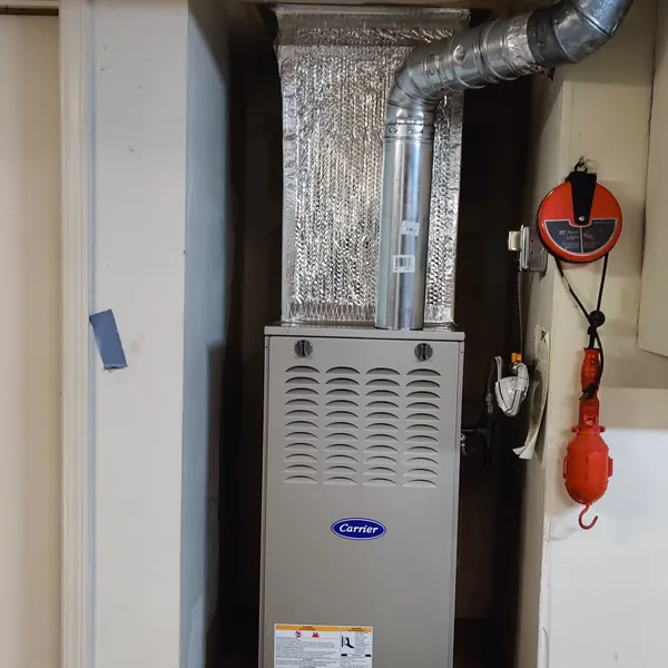 A new Carrier gas furnace in a wall alcove in a Foster City home
